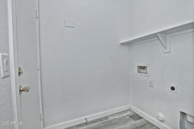 washroom featuring electric dryer hookup, light wood-type flooring, gas dryer hookup, and washer hookup