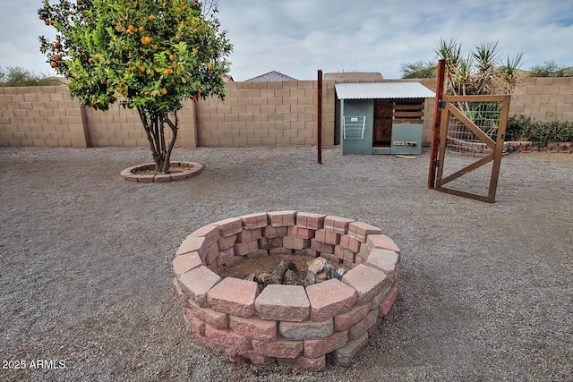 view of patio / terrace featuring an outbuilding and an outdoor fire pit