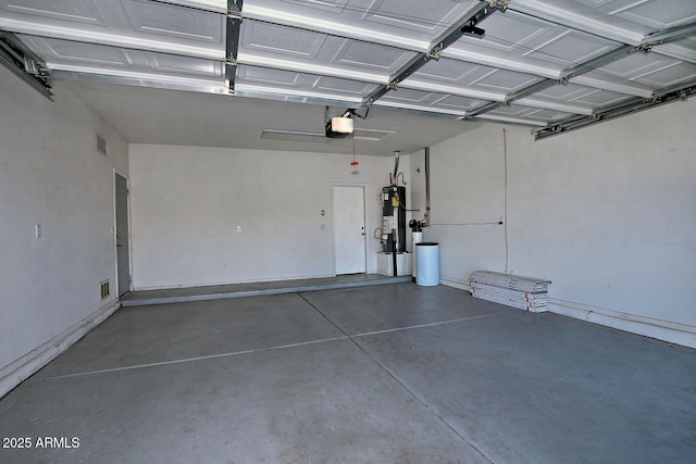 garage featuring a garage door opener and water heater