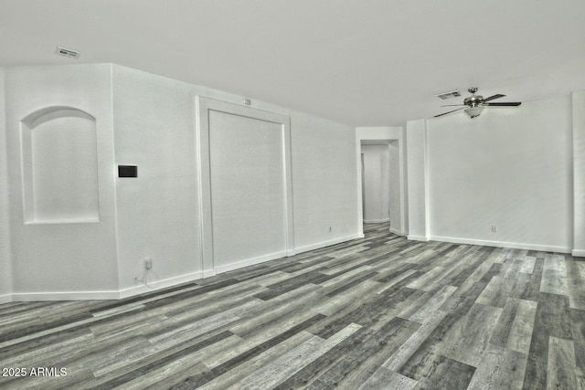 empty room with ceiling fan and dark hardwood / wood-style flooring