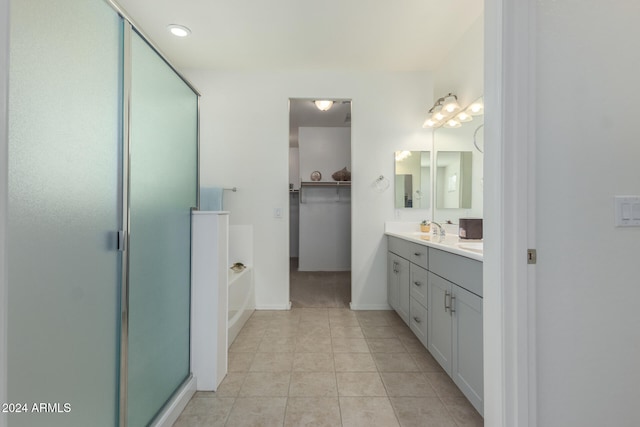 bathroom featuring tile patterned floors, vanity, and plus walk in shower