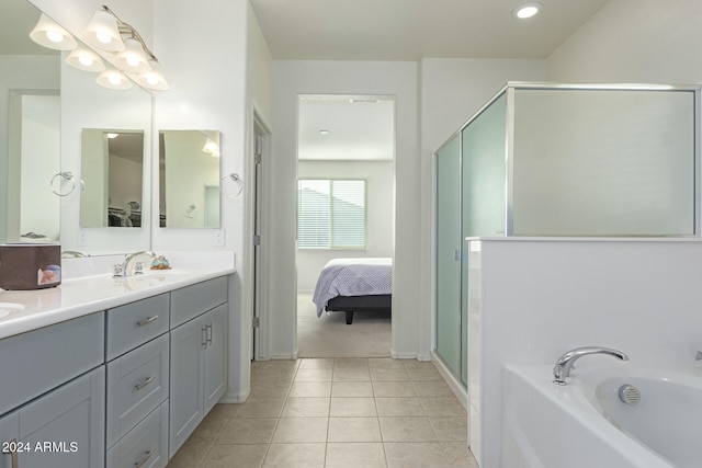 bathroom with tile patterned flooring, vanity, and independent shower and bath