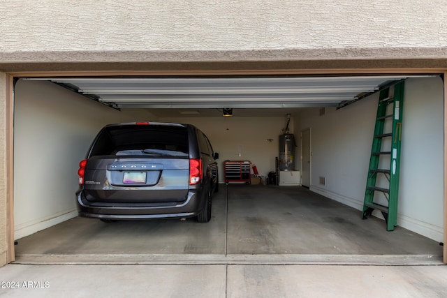 garage featuring secured water heater and a garage door opener