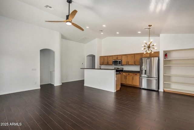 kitchen with ceiling fan with notable chandelier, high vaulted ceiling, hanging light fixtures, stainless steel appliances, and dark wood-type flooring