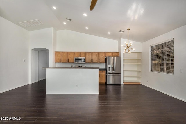 kitchen featuring dark wood-type flooring, a chandelier, high vaulted ceiling, appliances with stainless steel finishes, and pendant lighting