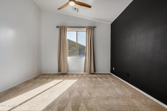 carpeted empty room featuring lofted ceiling and ceiling fan