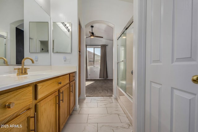 bathroom with ceiling fan, vanity, and shower / bath combination with glass door