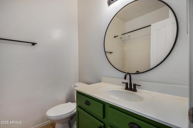 bathroom featuring vanity, toilet, and a shower