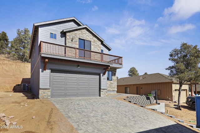 view of front of property with a garage and a balcony