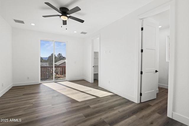 unfurnished bedroom with ceiling fan and dark hardwood / wood-style floors