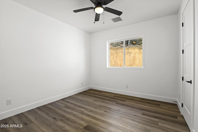 empty room with ceiling fan and dark hardwood / wood-style flooring