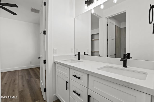 bathroom with ceiling fan, wood-type flooring, and vanity