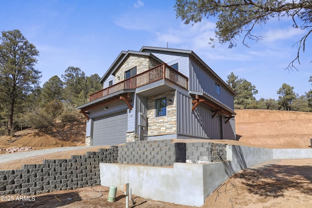 view of front of house with a garage and a balcony