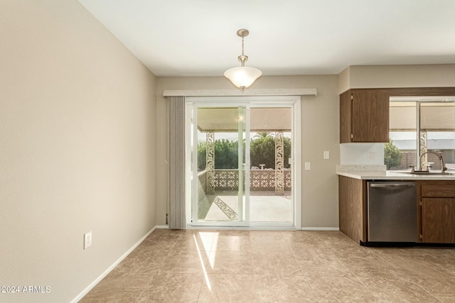 kitchen featuring pendant lighting, dishwasher, plenty of natural light, and sink