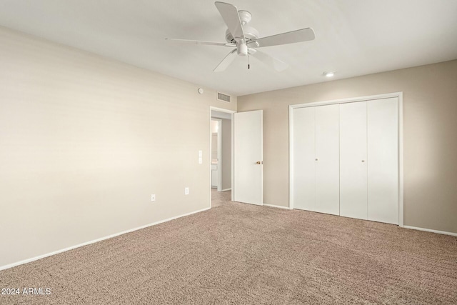 unfurnished bedroom featuring ceiling fan, a closet, and carpet floors