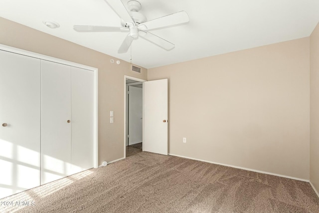 unfurnished bedroom with carpet flooring, a closet, and ceiling fan