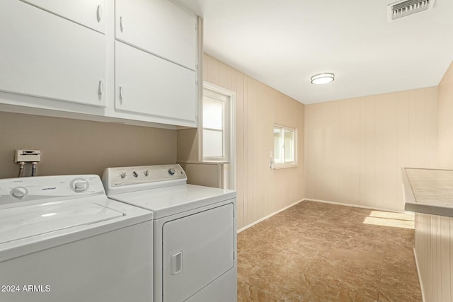 laundry room featuring cabinets and independent washer and dryer