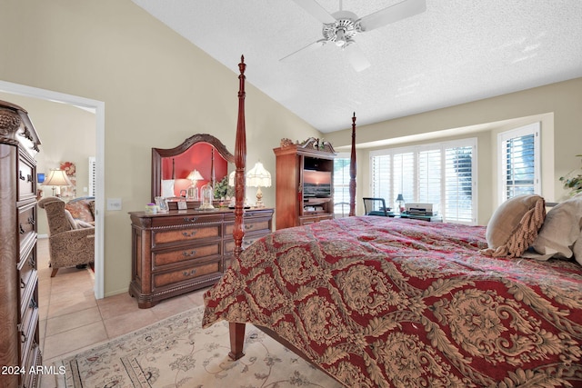 tiled bedroom with ceiling fan, a textured ceiling, and vaulted ceiling