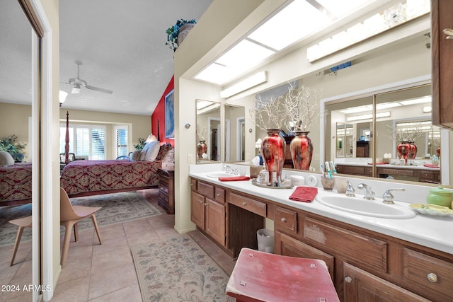 bathroom featuring vanity, a textured ceiling, tile patterned floors, and ceiling fan