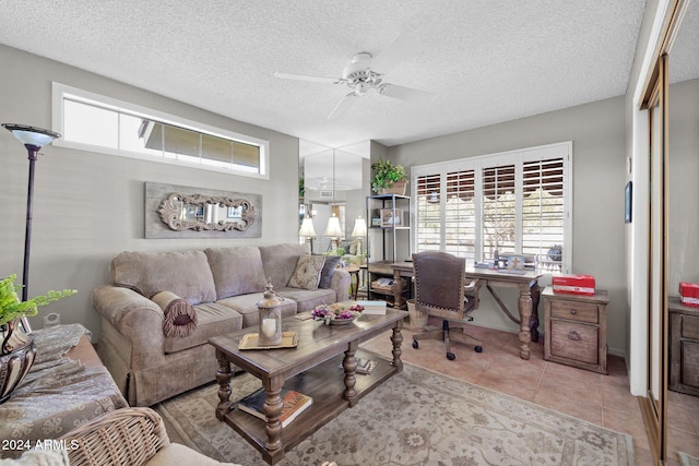 living room featuring ceiling fan and a textured ceiling