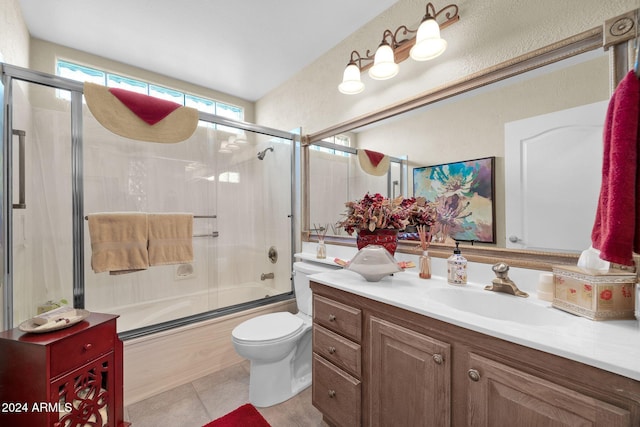 full bathroom with shower / bath combination with glass door, vanity, toilet, and tile patterned flooring