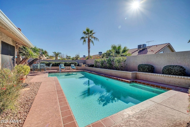 view of pool featuring central air condition unit