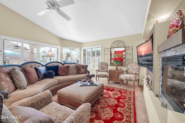 tiled living room with vaulted ceiling, ceiling fan, and a textured ceiling