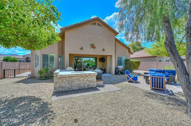 rear view of property with an outdoor living space with a fire pit, stucco siding, a fenced backyard, and a patio