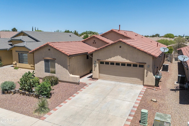 2003 Valley Sage St, Sierra Vista, AZ 85635 - mediterranean / spanish-style house featuring stucco siding, concrete driveway, an attached garage, and a tiled roof