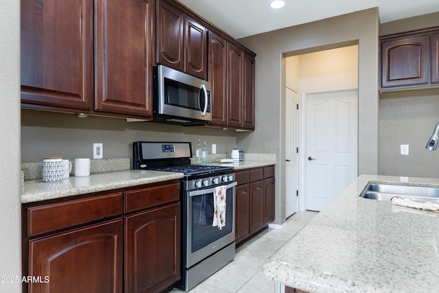 2003 Valley Sage St, Sierra Vista, AZ 85635 - kitchen with appliances with stainless steel finishes, a sink, light tile patterned floors, light stone countertops, and recessed lighting