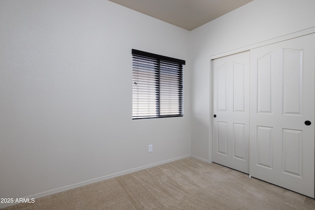 2003 Valley Sage St, Sierra Vista, AZ 85635 - unfurnished bedroom featuring light carpet, a closet, and baseboards
