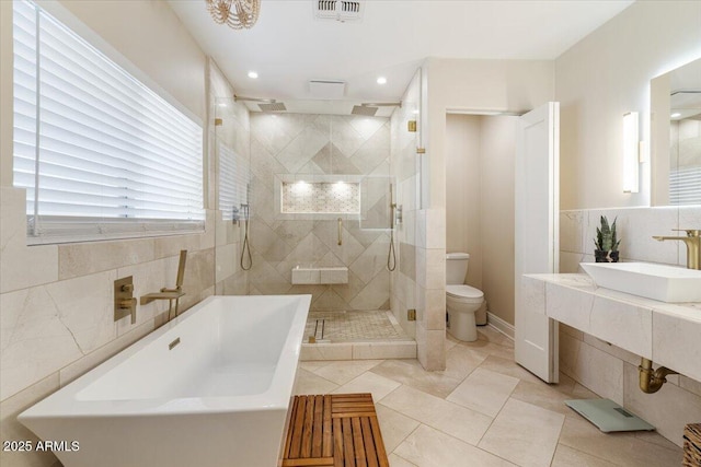 full bathroom featuring vanity, plus walk in shower, tile patterned floors, and toilet