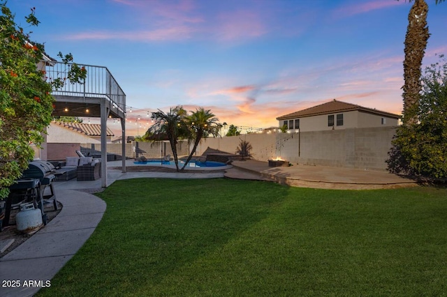 yard at dusk featuring a patio and a fenced in pool