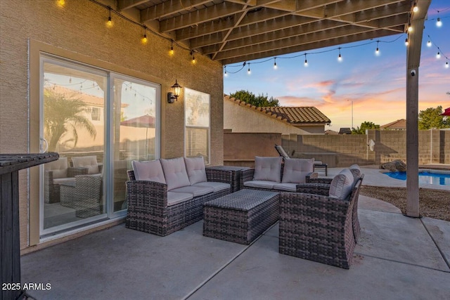 patio terrace at dusk featuring outdoor lounge area