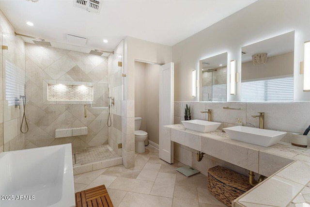 bathroom featuring toilet, an enclosed shower, tile patterned floors, and vanity