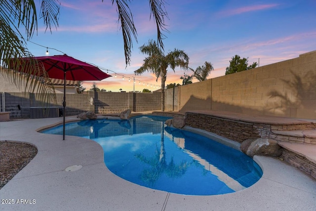 view of pool at dusk