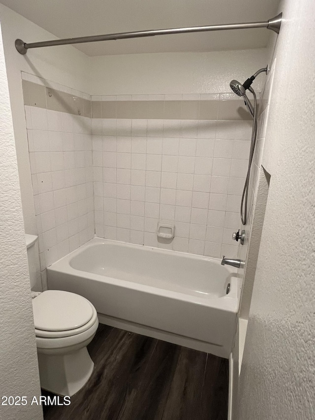 4850 E Desert Cove Ave Unit 241, Scottsdale, AZ 85254 - full bathroom featuring a textured wall, wood finished floors, toilet, and  shower combination