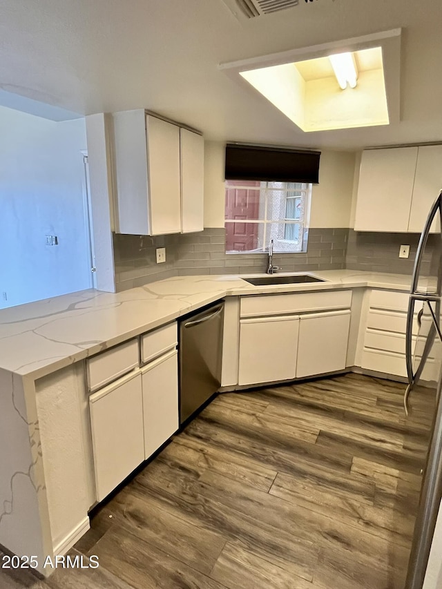 4850 E Desert Cove Ave Unit 241, Scottsdale, AZ 85254 - kitchen with stainless steel dishwasher, a sink, white cabinets, dark wood-style flooring, and light stone counters