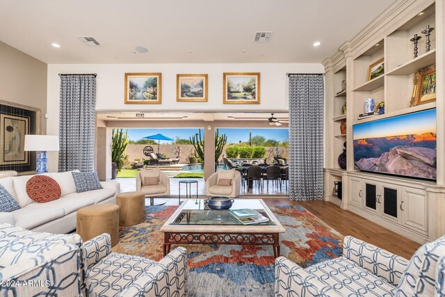 living room featuring light hardwood / wood-style flooring and built in features