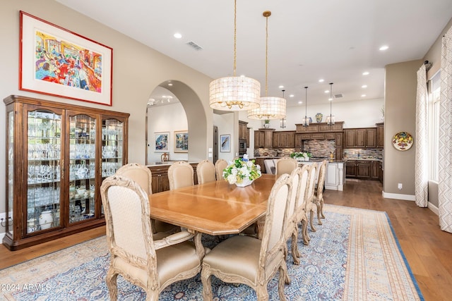 dining area with an inviting chandelier and light wood-type flooring