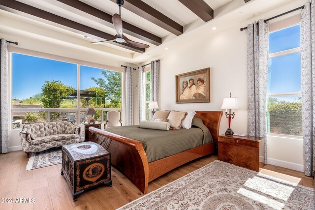 bedroom with ceiling fan, beam ceiling, and hardwood / wood-style floors