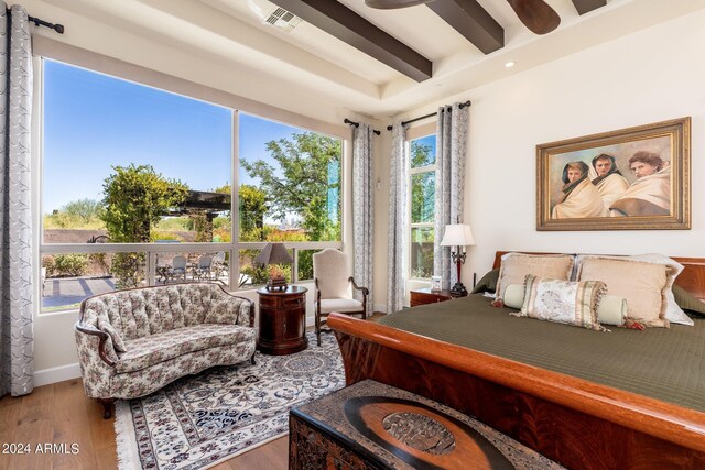 bedroom featuring ceiling fan, beamed ceiling, and hardwood / wood-style flooring