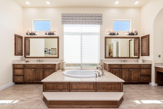 bathroom with vanity, tile patterned flooring, and a washtub