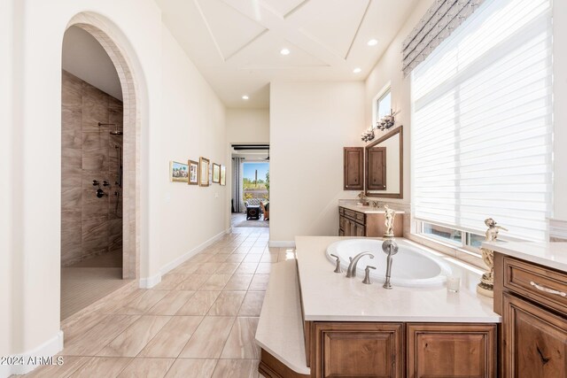 bathroom with tile patterned floors, independent shower and bath, and vanity