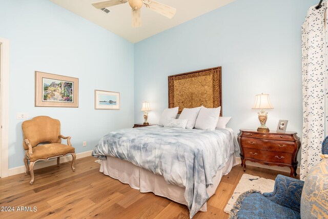 bedroom with ceiling fan and light hardwood / wood-style flooring