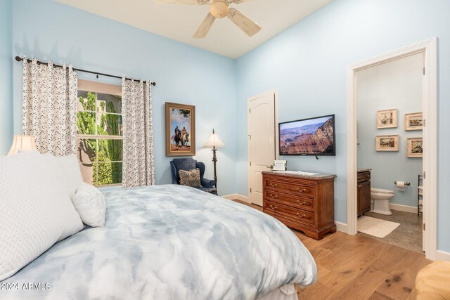 bedroom with light hardwood / wood-style floors, ensuite bathroom, and ceiling fan