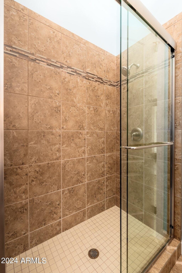 bathroom with a shower with shower door