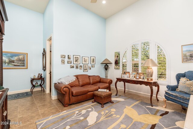 living room featuring ceiling fan and high vaulted ceiling