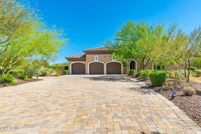 mediterranean / spanish-style house featuring a garage