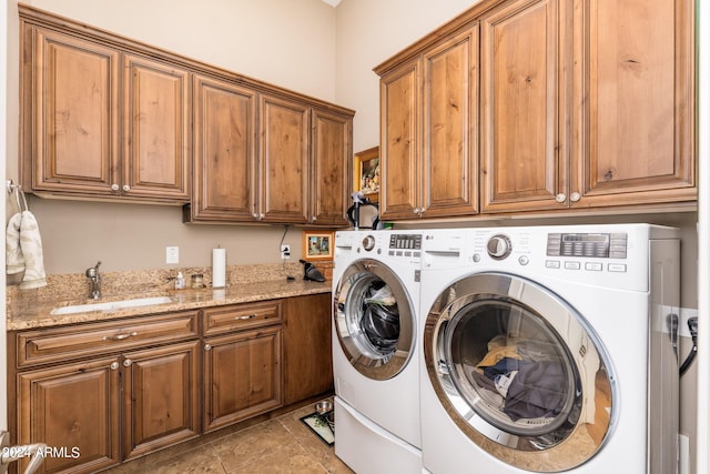 laundry room with cabinets, independent washer and dryer, light tile patterned floors, and sink